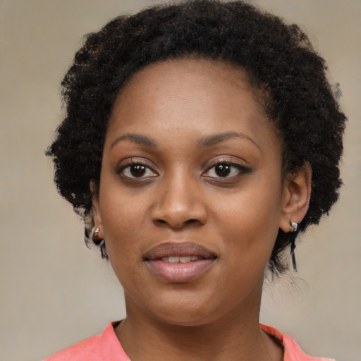 Joyful black young-adult female with medium  black hair and brown eyes