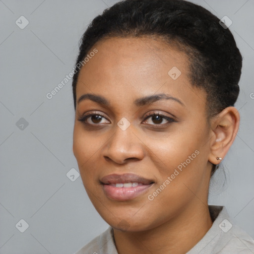 Joyful black young-adult female with short  black hair and brown eyes