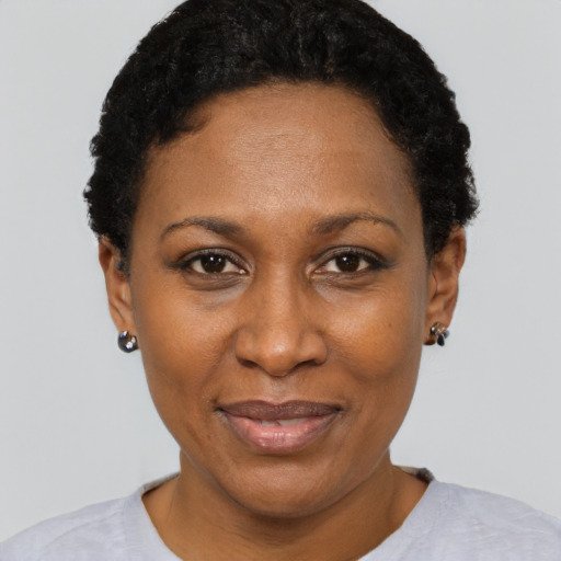 Joyful black adult female with short  black hair and brown eyes