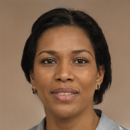 Joyful black adult female with medium  black hair and brown eyes