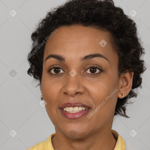 Joyful black adult female with short  brown hair and brown eyes