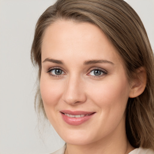 Joyful white young-adult female with medium  brown hair and blue eyes