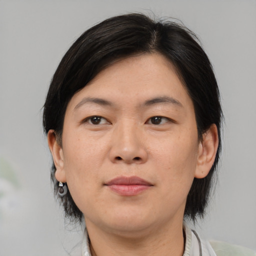 Neutral asian adult female with medium  brown hair and brown eyes
