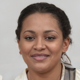 Joyful latino adult female with medium  brown hair and brown eyes