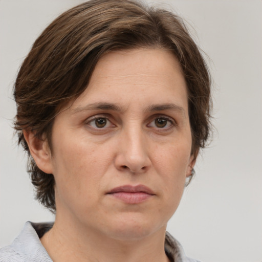 Joyful white adult female with medium  brown hair and grey eyes