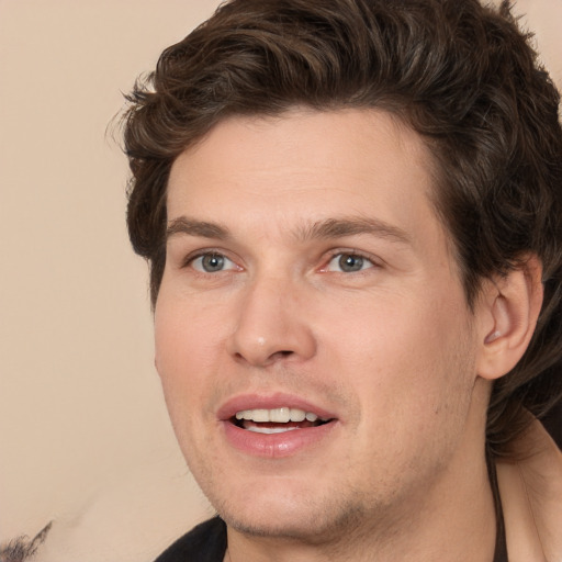 Joyful white young-adult male with medium  brown hair and brown eyes