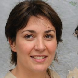 Joyful white adult female with medium  brown hair and brown eyes