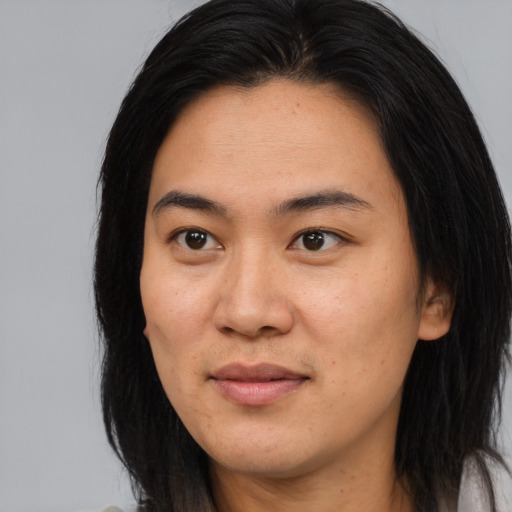 Joyful asian young-adult female with long  brown hair and brown eyes