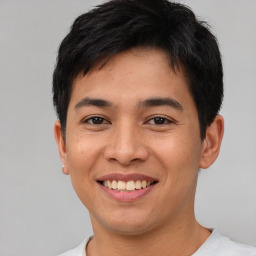 Joyful asian young-adult male with short  brown hair and brown eyes