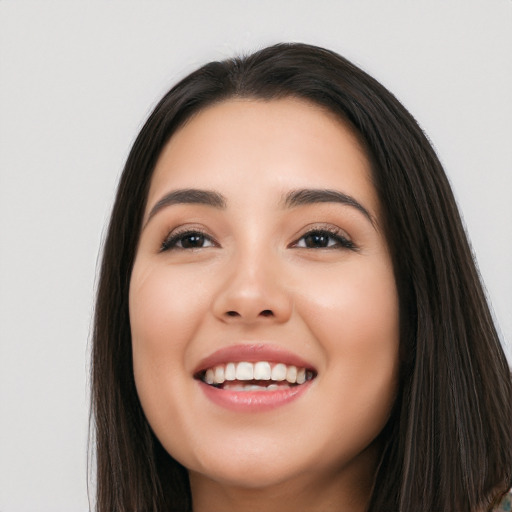 Joyful white young-adult female with long  black hair and brown eyes