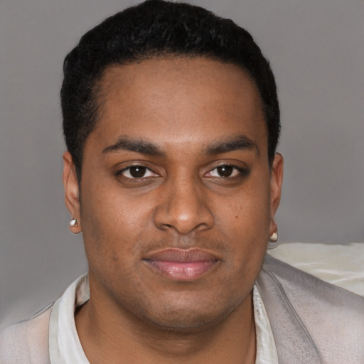 Joyful latino young-adult male with short  black hair and brown eyes