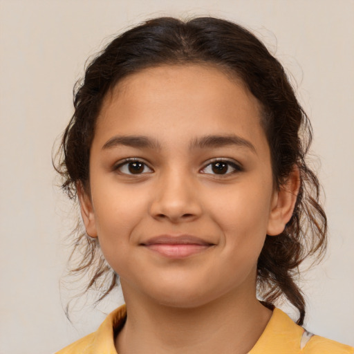 Joyful latino child female with medium  brown hair and brown eyes