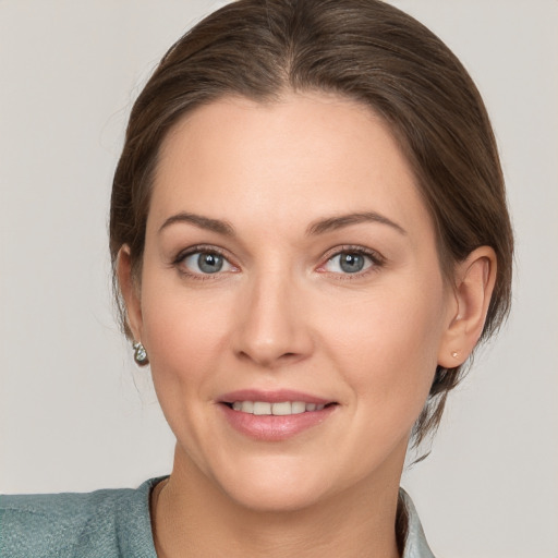 Joyful white adult female with medium  brown hair and grey eyes