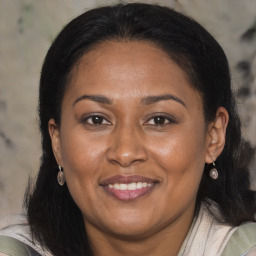 Joyful black adult female with medium  brown hair and brown eyes