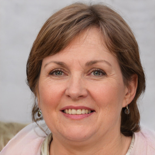 Joyful white adult female with medium  brown hair and blue eyes