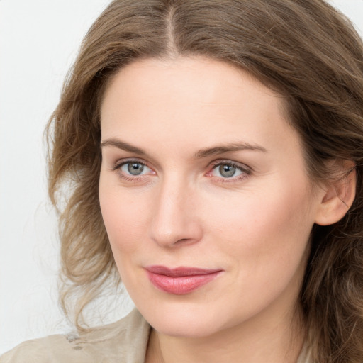 Joyful white young-adult female with long  brown hair and blue eyes