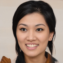 Joyful asian young-adult female with medium  black hair and brown eyes