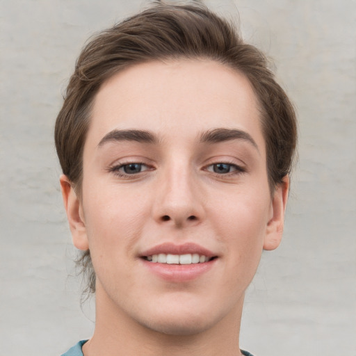 Joyful white young-adult female with short  brown hair and grey eyes