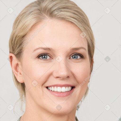 Joyful white young-adult female with medium  brown hair and blue eyes