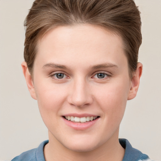 Joyful white young-adult female with short  brown hair and grey eyes