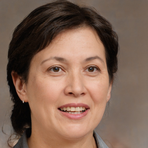 Joyful white adult female with medium  brown hair and brown eyes