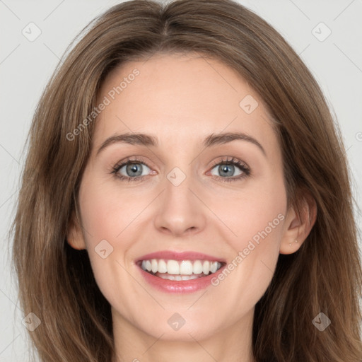 Joyful white young-adult female with long  brown hair and grey eyes