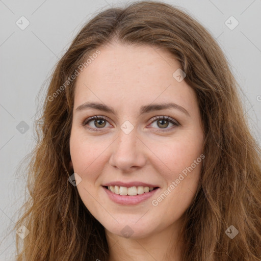 Joyful white young-adult female with long  brown hair and green eyes