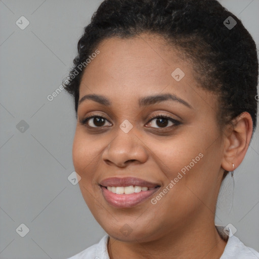 Joyful black young-adult female with short  brown hair and brown eyes