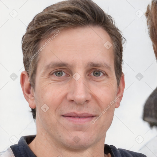 Joyful white adult male with short  brown hair and grey eyes