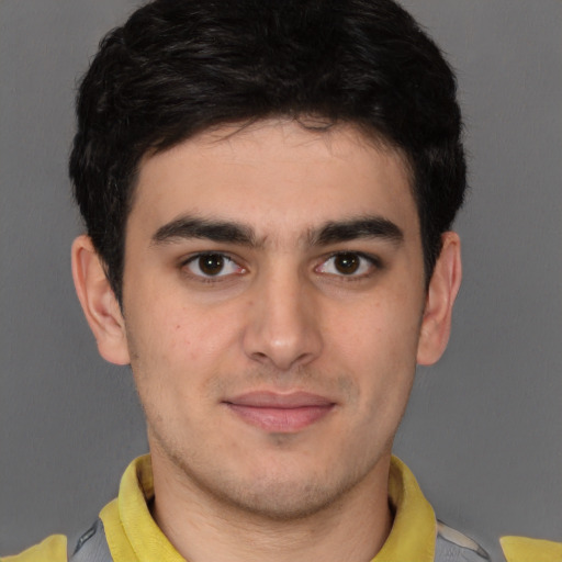 Joyful latino young-adult male with short  brown hair and brown eyes