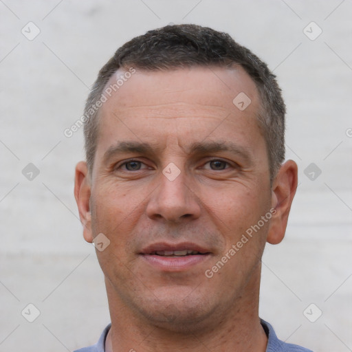 Joyful white adult male with short  brown hair and brown eyes