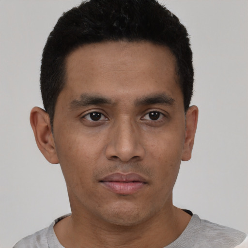 Neutral latino young-adult male with short  black hair and brown eyes