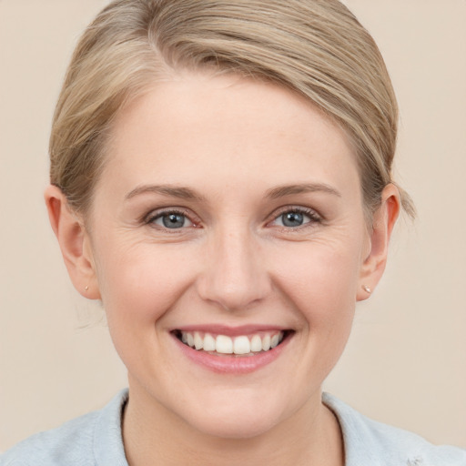 Joyful white young-adult female with medium  brown hair and blue eyes