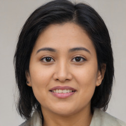 Joyful latino young-adult female with medium  brown hair and brown eyes