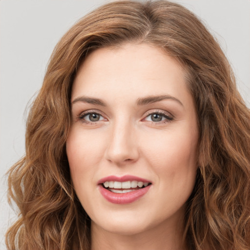 Joyful white young-adult female with long  brown hair and green eyes