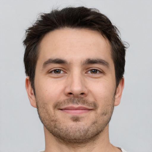 Joyful white young-adult male with short  brown hair and brown eyes