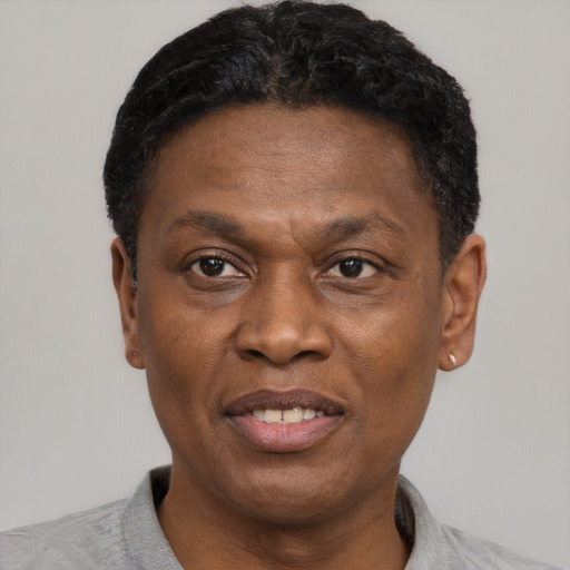 Joyful black adult male with short  black hair and brown eyes