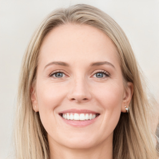 Joyful white young-adult female with long  brown hair and blue eyes