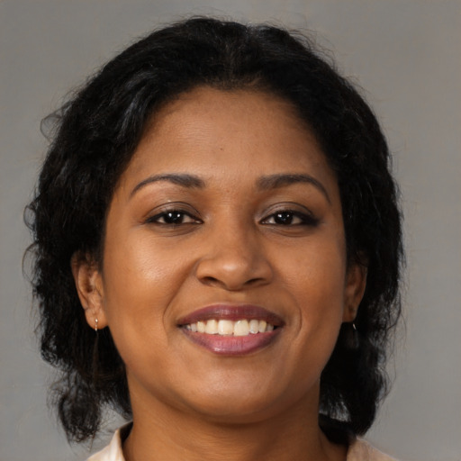 Joyful black young-adult female with medium  brown hair and brown eyes