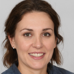 Joyful white adult female with medium  brown hair and brown eyes