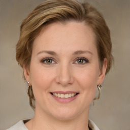 Joyful white young-adult female with medium  brown hair and green eyes