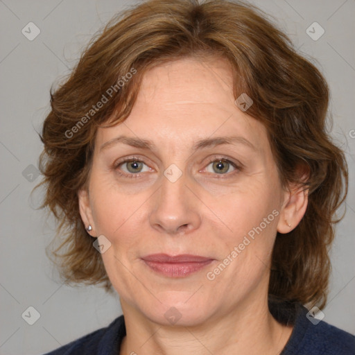 Joyful white adult female with medium  brown hair and blue eyes