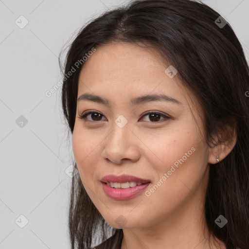 Joyful asian young-adult female with long  brown hair and brown eyes