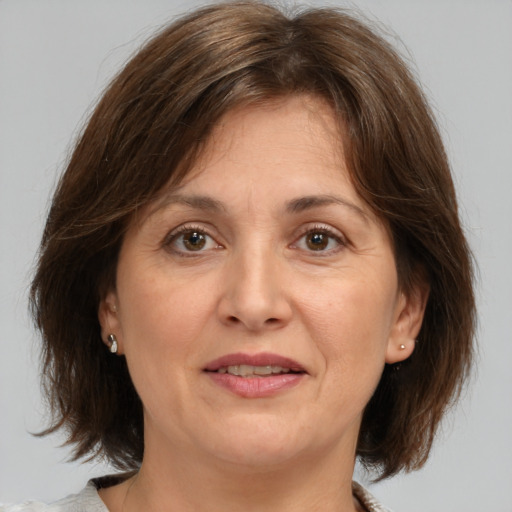 Joyful white adult female with medium  brown hair and brown eyes