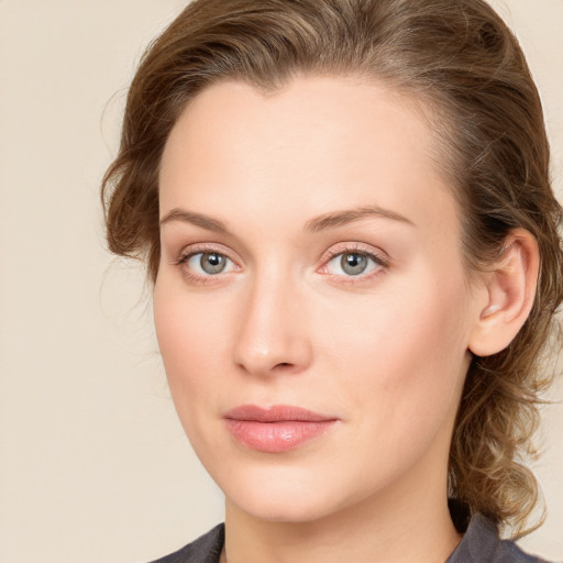 Joyful white young-adult female with medium  brown hair and blue eyes