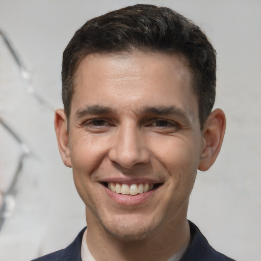 Joyful white adult male with short  brown hair and brown eyes