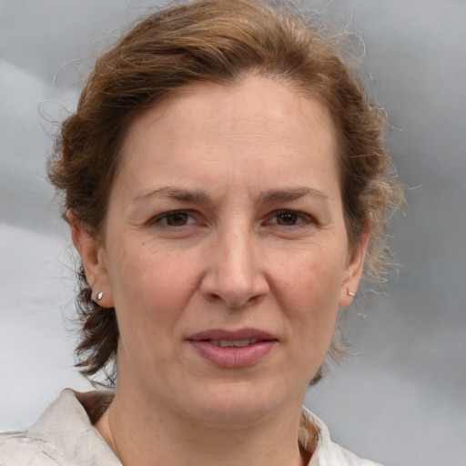 Joyful white adult female with medium  brown hair and brown eyes