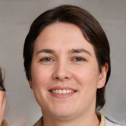 Joyful white adult female with medium  brown hair and brown eyes