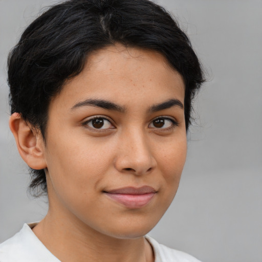 Joyful latino young-adult female with medium  brown hair and brown eyes