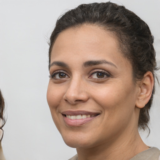 Joyful white young-adult female with medium  brown hair and brown eyes